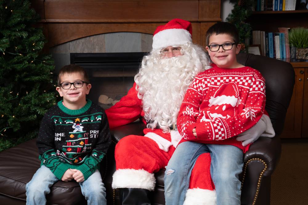 Two kids sitting with Santa.